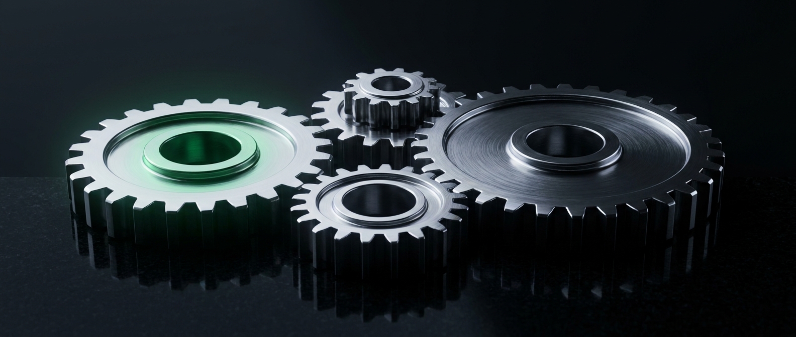 Four interlocking chrome gears, one glowing emerald